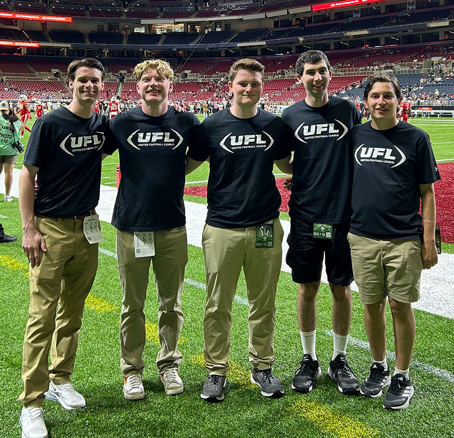 Danny Baris standing on athletic field with four other youngmen