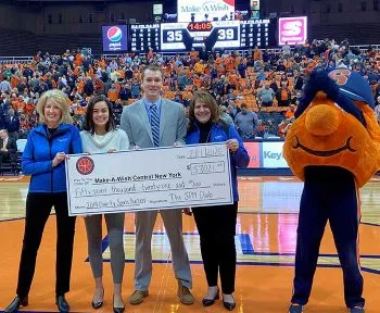 SPM club members present a check to Make-A-Wish reps