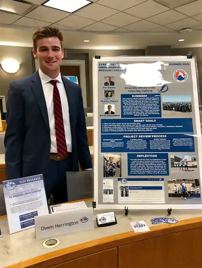 Owen Herrington standing behind a desk