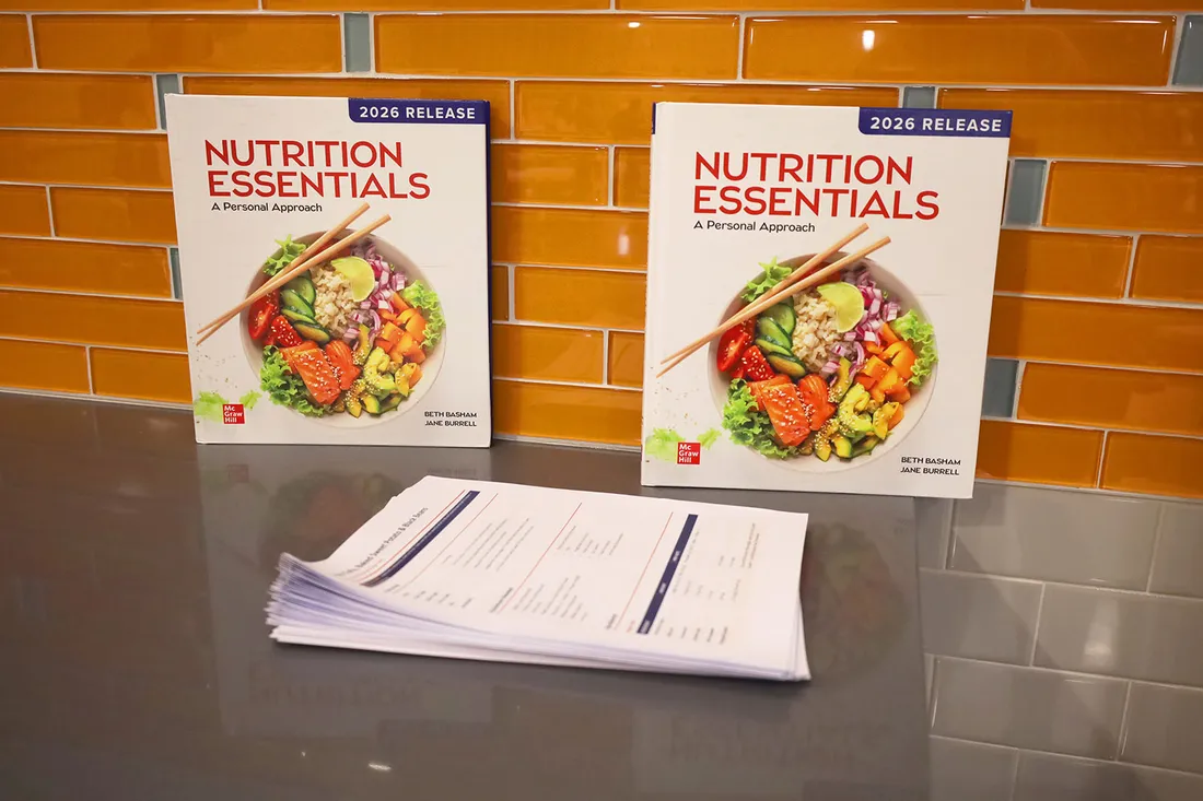 Two cooking textbooks are posed on a cooking surface.
