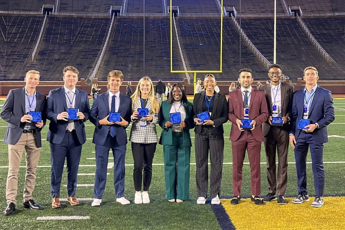 10 students lined up on athletic field