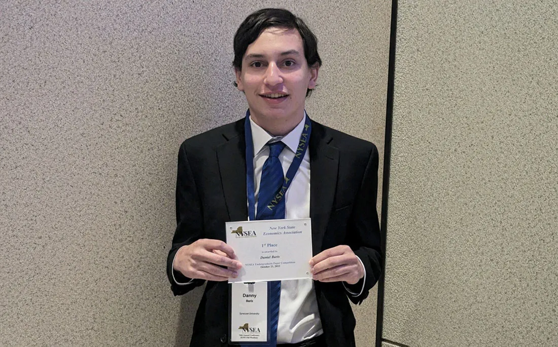 Danny Baris holding up award he won