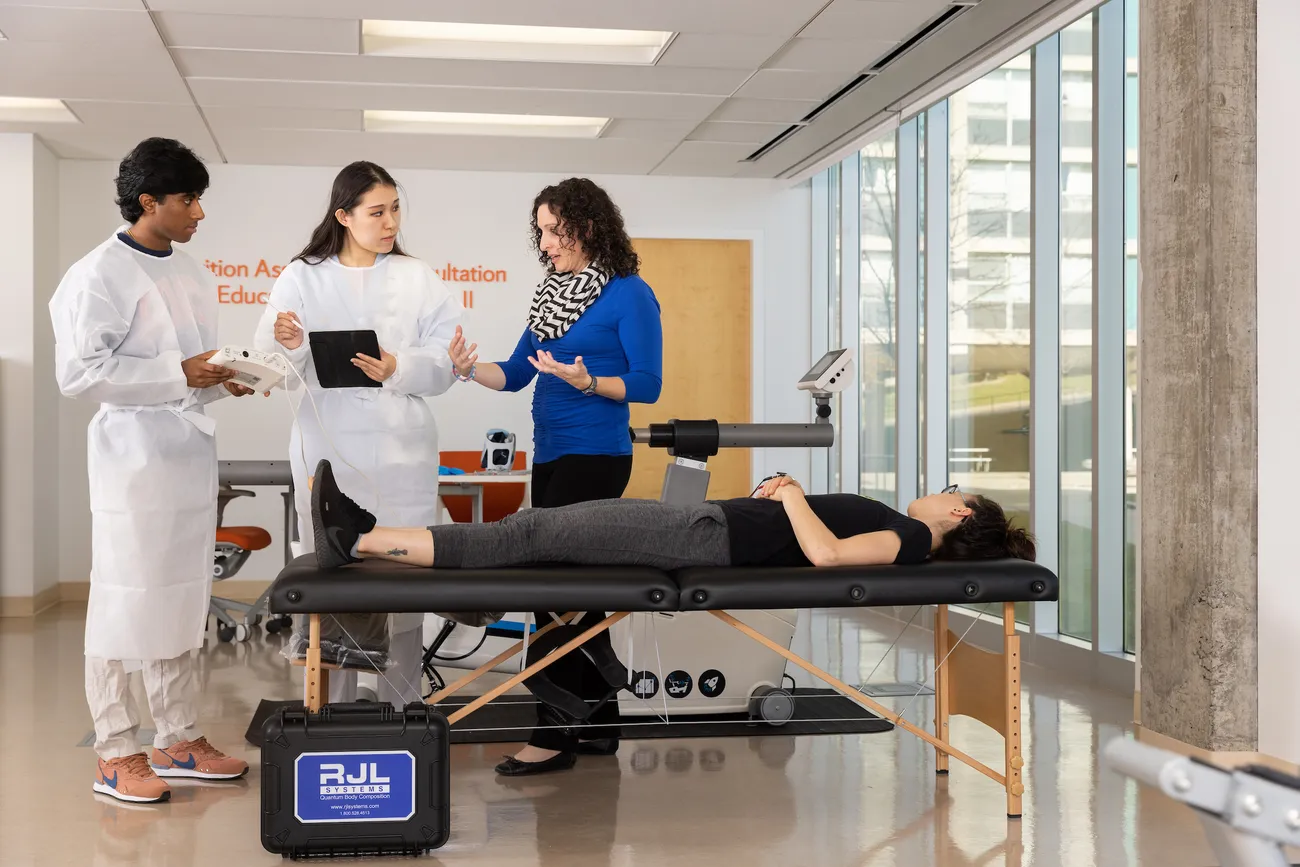 Students work with a professor in a lab