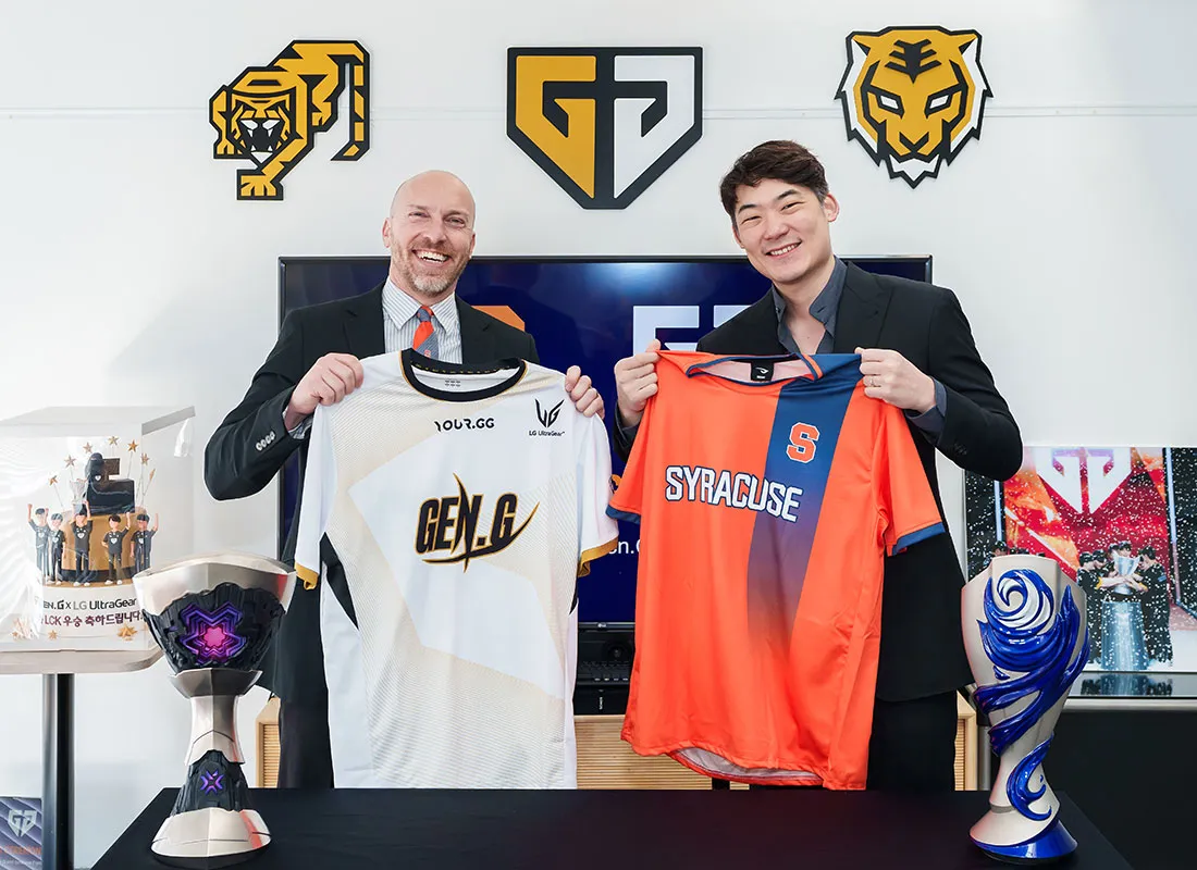 Professor Joey with GenG leader hold sport shirts