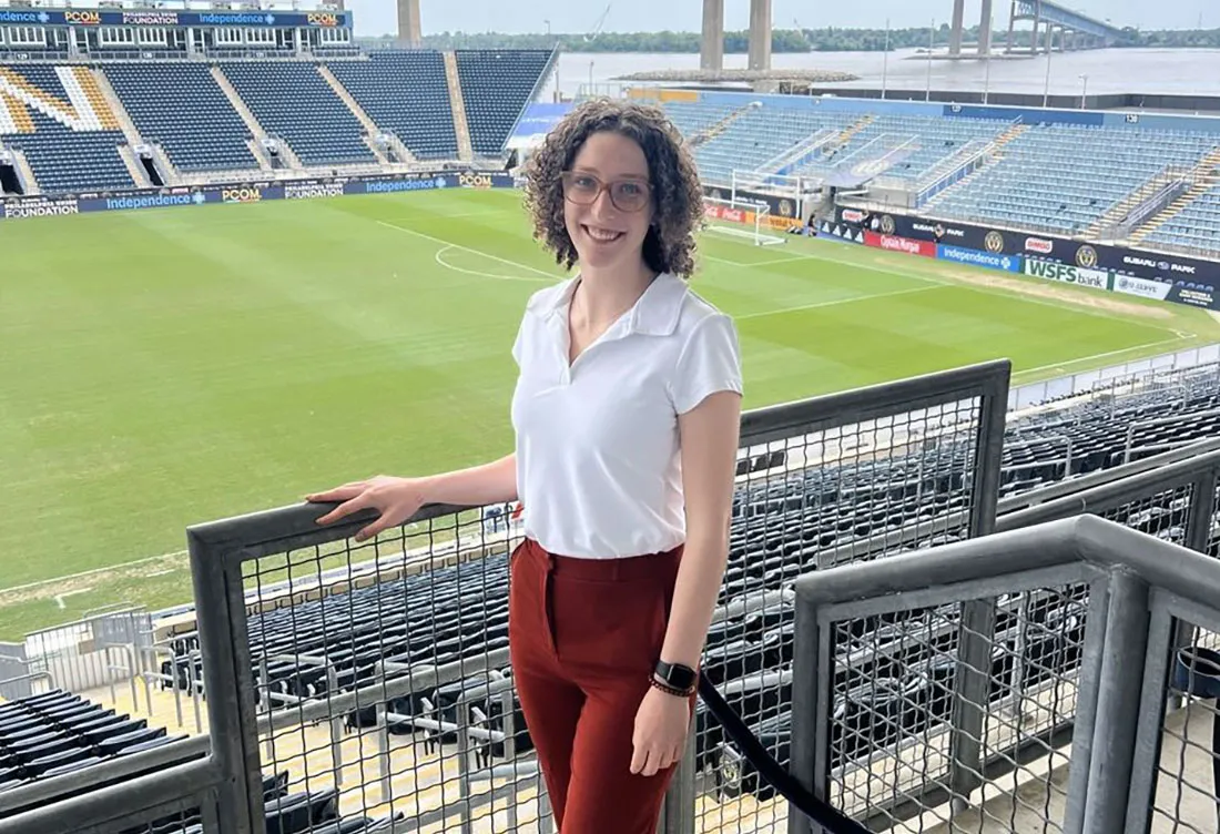 Female student standing in empty stadium