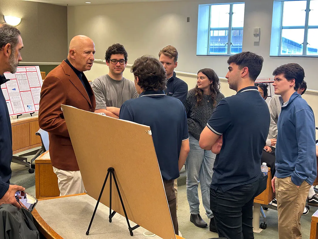 David Falk talking with students during poster presentation