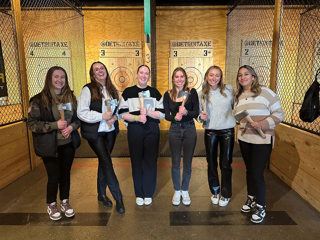 six female students tried axe-throwing while in Detroit for NFL draft