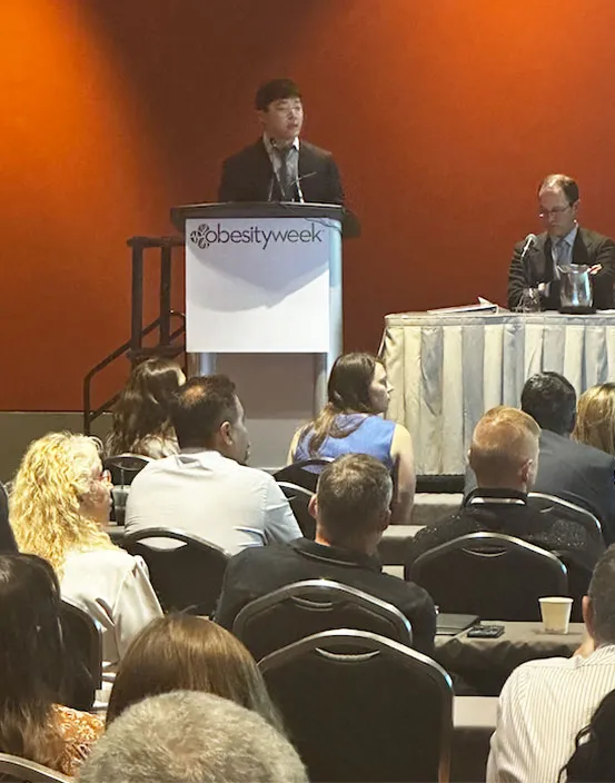 doctoral student presenting at a conference