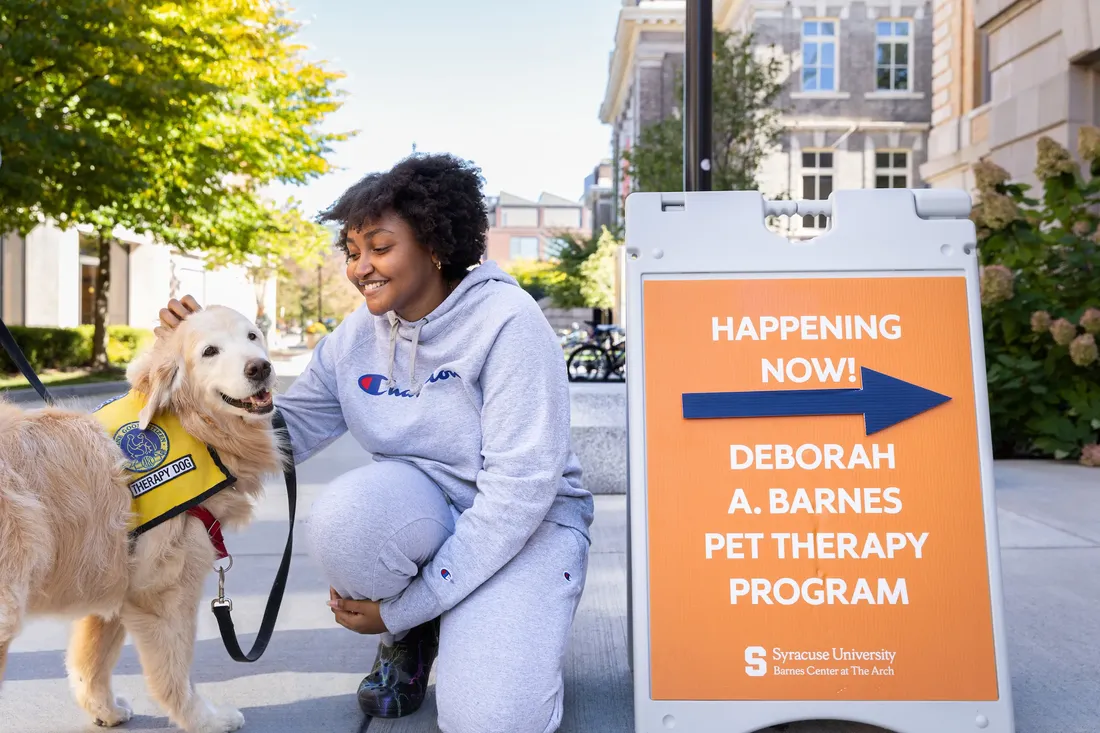 Student petting a therapy dog