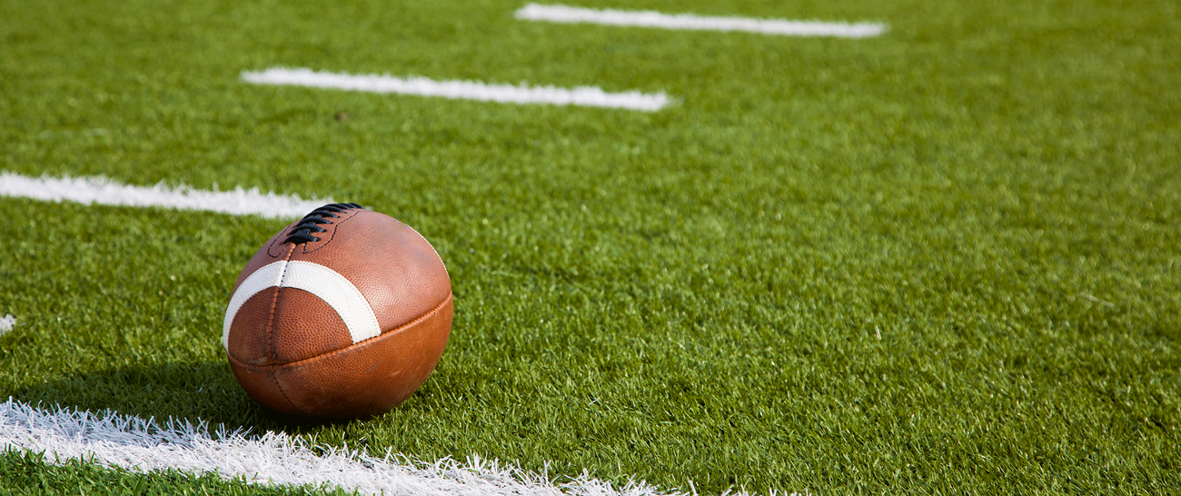 football at scrimmage line on athletic field