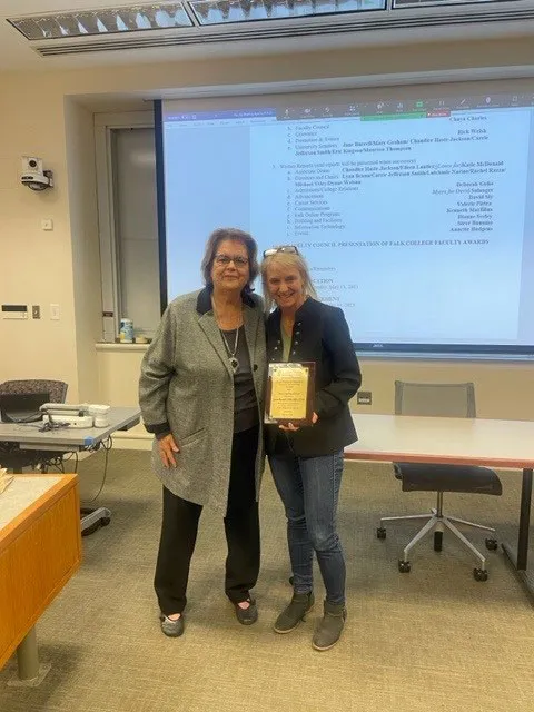 Professor receiving faculty award from Dean