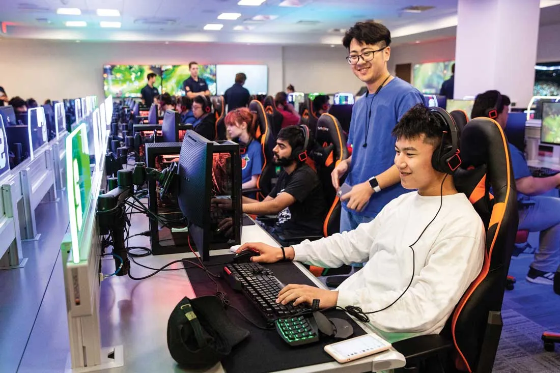 students sitting and observing other students at new esports gaming stations