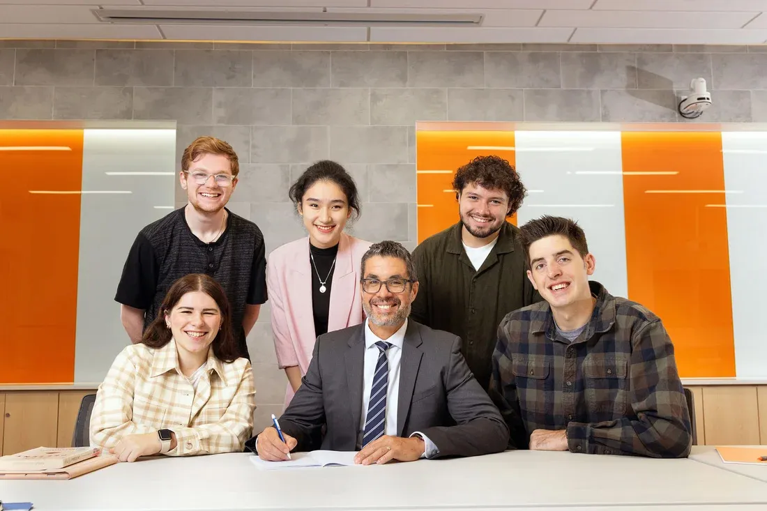 Dean Jordan posing with 5 students