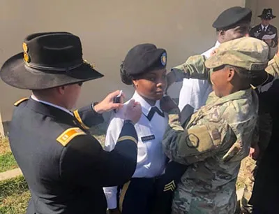 female service person receiving medals