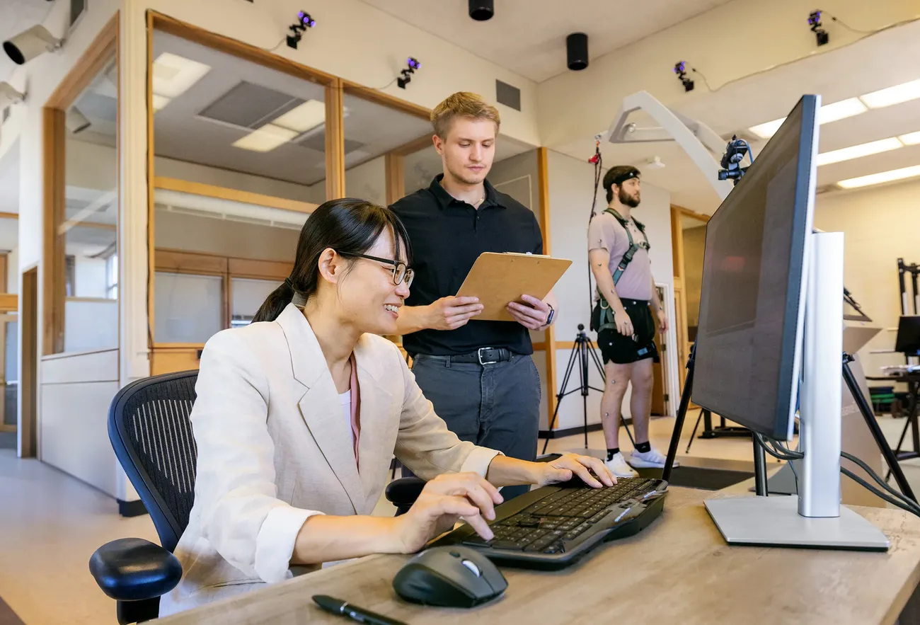 Professor working in exercise science lab with students