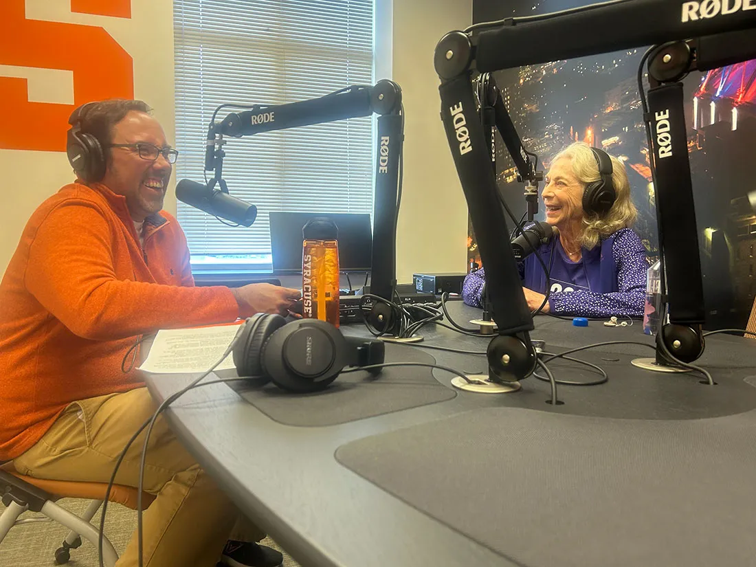 K. Switzer sitting at table while doing podcast