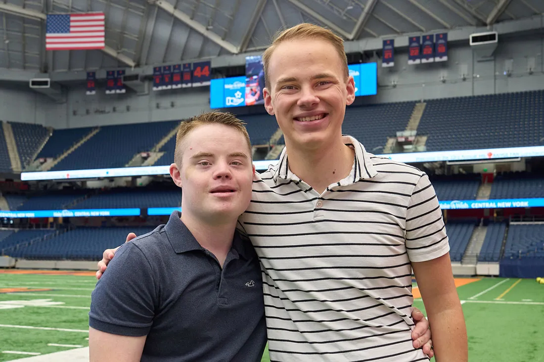 Radel brothers standing side by side on athletic field