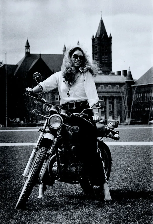 female professor sitting on a motorcycle