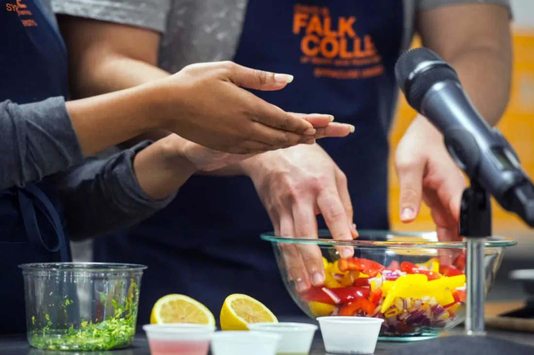 two pairs of hands preparing food
