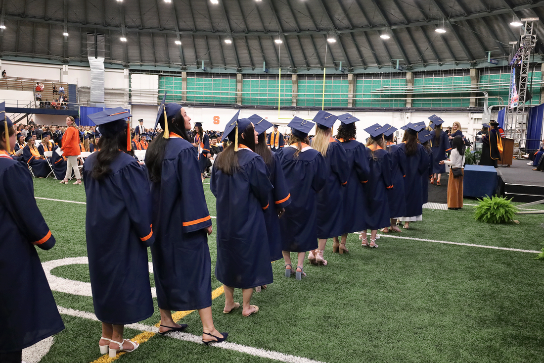 student lined up to get diplomas at convocation