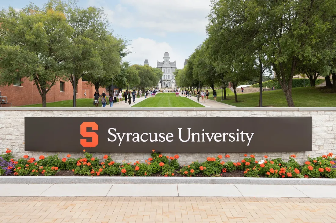 A view of Hall of Languages from the Syracuse University Entrance Sign