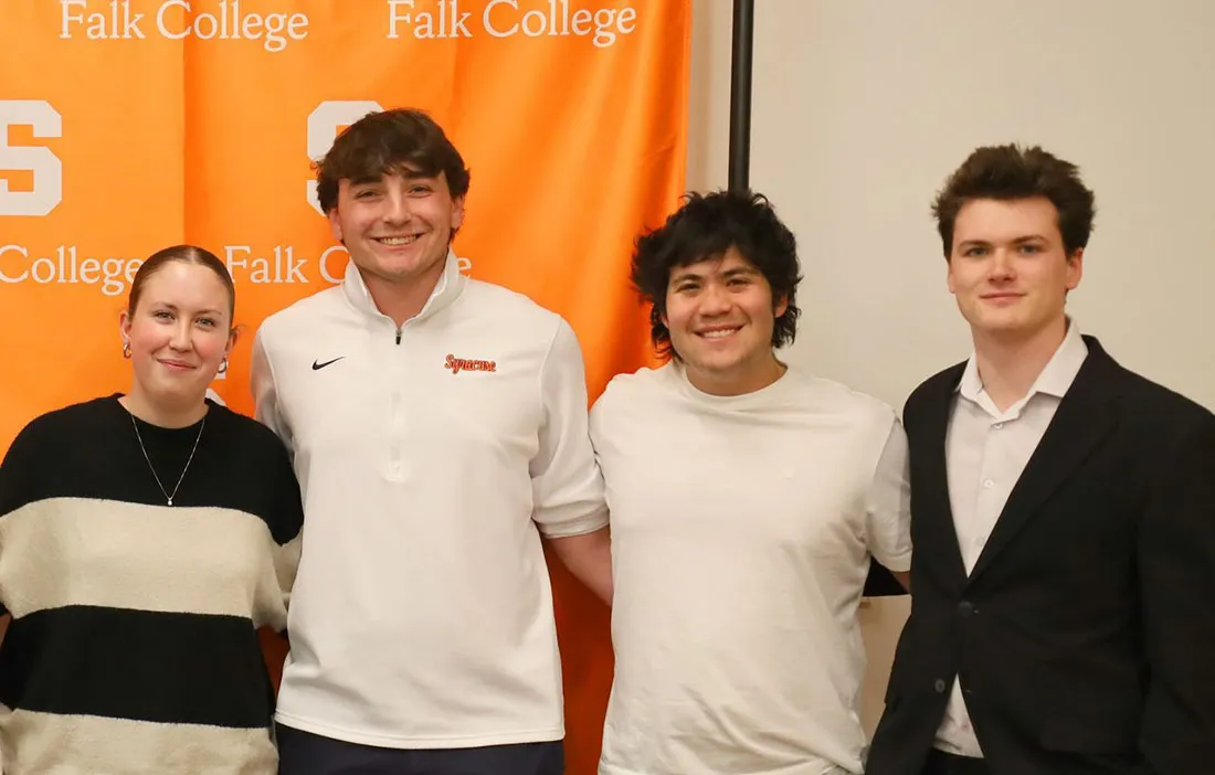 Sport Management scholars standing together. one female student and three males