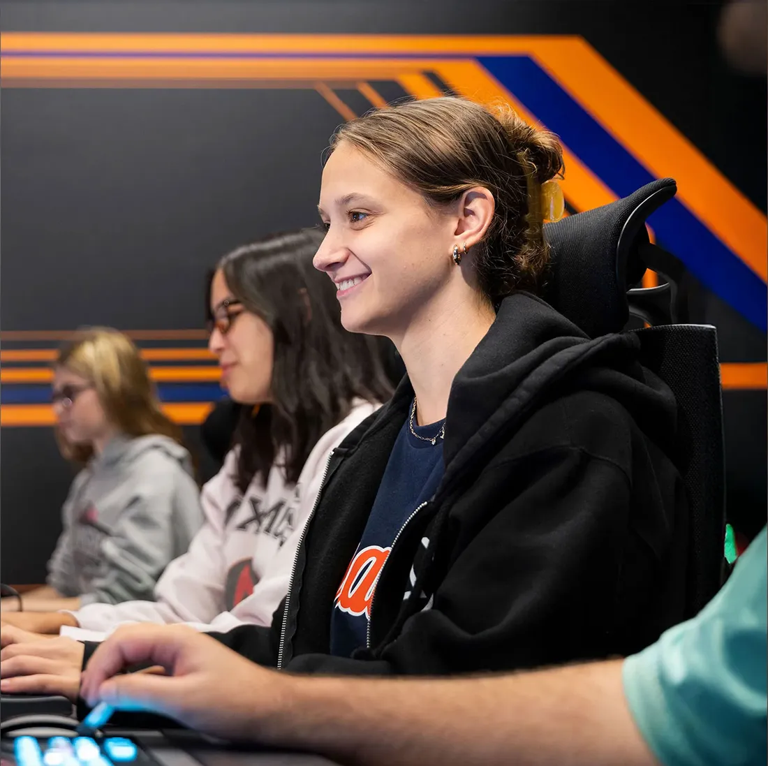 3 students at esports gaming stations