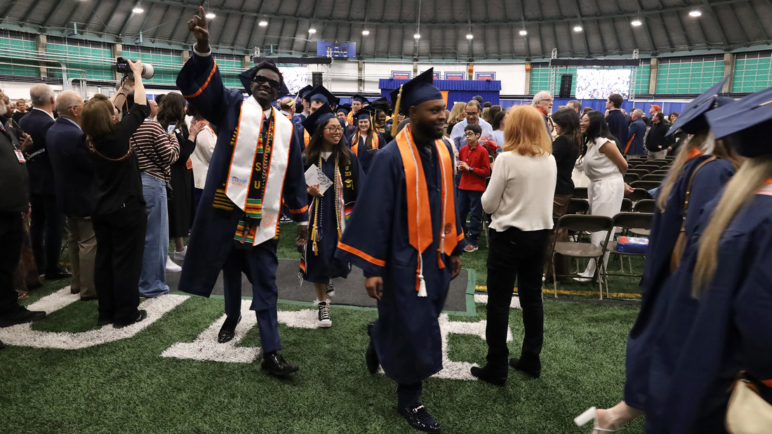 students celebrate as they exit convocation