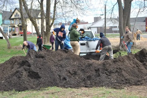 Students help prepare community gardens for planting.