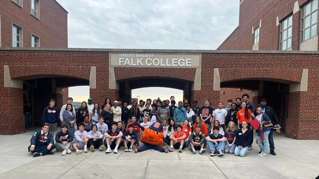 large group of Utica City students gathered in front of the patio at Falk College