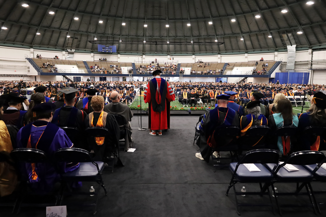 from behind stage of convocation looking out at audience