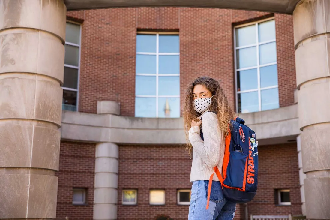 Eva Scott wearing a mask outside of Falk College Barclay hall circle