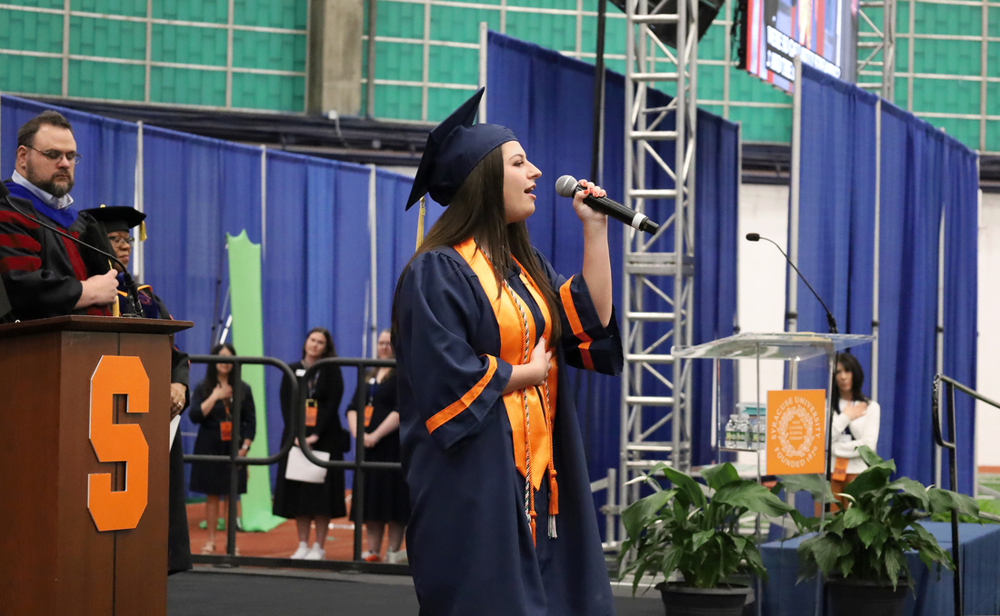 student Gianna Sanzone sings the star-spangled banner