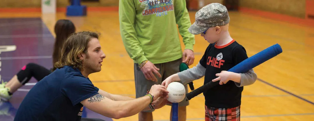 An exercise Science student works will a small child who is blind