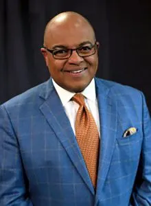portrait of black man wearing a suit and smiling